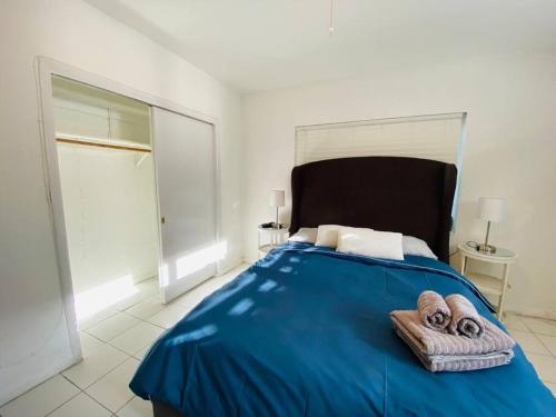 迈阿密Coral Gables / Coconut Grove area FREE parking的一间卧室配有蓝色的床和毛巾