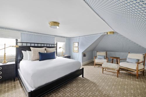肯尼邦克港肯尼邦克港酒店的卧室配有一张白色大床和椅子