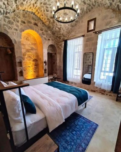 马尔丁TUĞMANER Small House AJAR的石头建筑中一间带大床的卧室