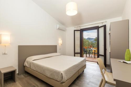 包内伊Il Rifugio的一间卧室配有一张床、一张桌子和一张桌子