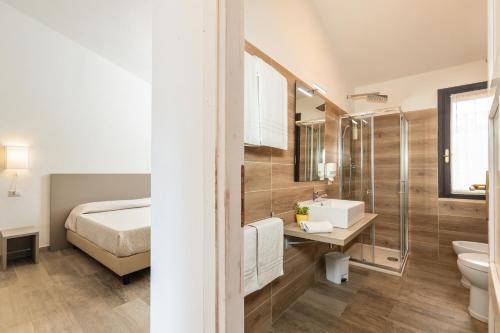 包内伊Il Rifugio的一间带床、水槽和卫生间的浴室