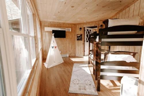 加特林堡Cabin with Treehouse Views, 3 King Beds, 4 Bunks, and Large Hot Tub!的一间带双层床和游乐帐篷的房间