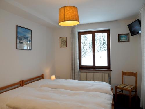 法尔西德多洛米蒂酒店的卧室配有白色的床和窗户。