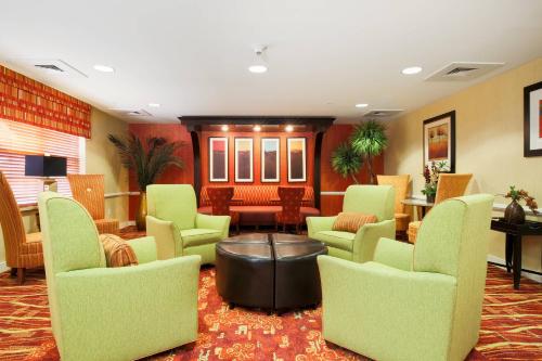 阿尔伯克基Residence Inn by Marriott Albuquerque North的一间设有绿色椅子和桌子的等候室