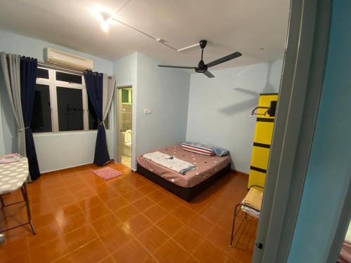 Kampong Tanah MerahMr Singh Homestay的一间卧室配有一张床和吊扇