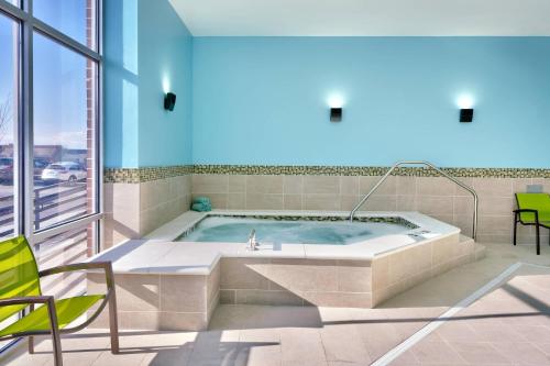 盐湖城SpringHill Suites by Marriott Salt Lake City Sugar House的一个带窗户的客房内的按摩浴缸