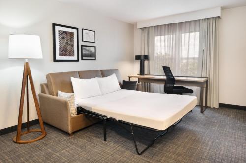 代托纳海滩万豪居家酒店代托纳比奇赛道/机场店的配有一张床和一张书桌的酒店客房
