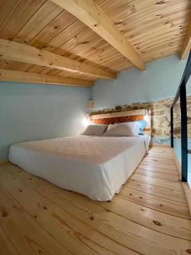 干尼亚Maria`s Peaceful Nest的一间卧室设有一张大床,铺有木地板。