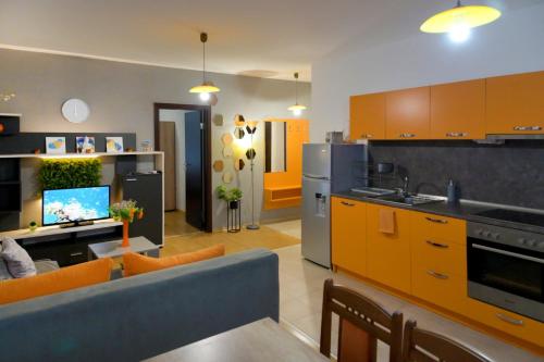 帕莫瑞Aglaya 2的厨房以及带橙色橱柜和蓝色沙发的客厅。