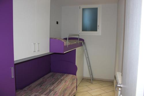 奥梅尼亚Casa Simone的客房配有紫色双层床和镜子