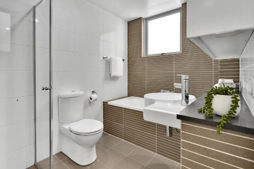 悉尼North Sydney Large Two Bedroom MIL2302的白色的浴室设有卫生间和水槽。