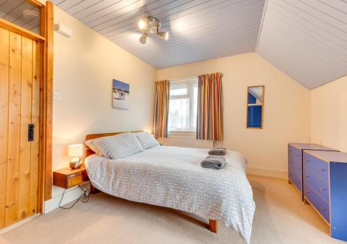 布罗德斯泰Goodwin Cottage的一间卧室设有一张大床和一个窗户。