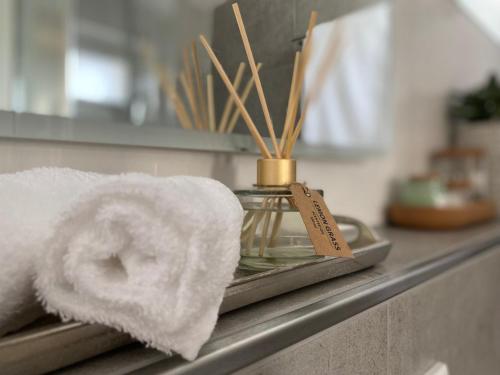 代特莫尔德QT Apartments Detmold的浴室柜台上毛巾和毛巾