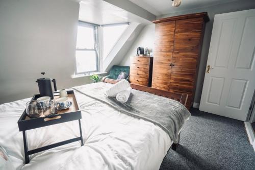 科芙Modern Penthouse Apartment in Cobh Town的一间卧室配有一张大床,上面有桌子