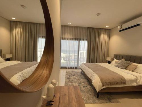 马斯喀特Turquaze Guesthouse的一间大卧室,配有两张床和镜子