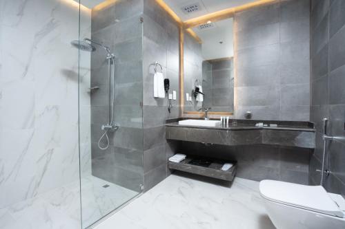 多哈AKASIYA HOTEL的带淋浴、盥洗盆和卫生间的浴室