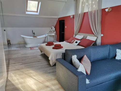MalansacLes lits de l'Arz的一间带沙发、床和浴缸的卧室
