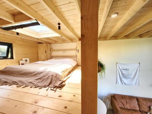 东卡佩勒NEW! Tiny House Lantliv Oostkapelle, bij de boer的小木屋内的卧室,配有床