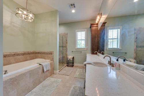 查尔斯湖Spacious Lake Charles Craftsman - Pet Friendly!的浴室配有2个盥洗盆、浴缸和淋浴。