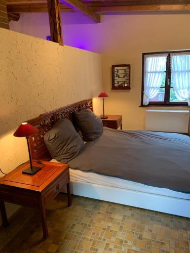 迪尔巴克Trusties的一间卧室配有一张床和一张带台灯的桌子