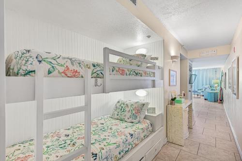 德斯坦Pelican Beach Resort Rentals的一间带两张双层床的卧室和走廊