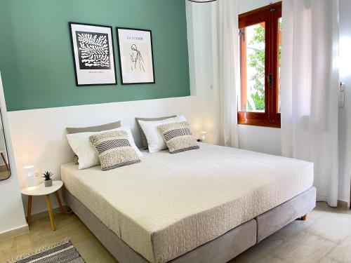 加藤-达拉特索Katerina Sea Apartments的一间卧室配有一张带蓝色墙壁的大床