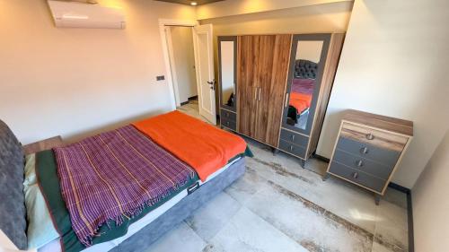 库萨达斯PALM BEACH APARTMENT的一间小卧室,配有一张床和镜子