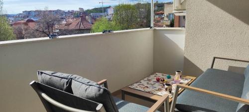 布拉戈耶夫格勒Kiki Home的小阳台配有两把椅子和一张桌子,还有一个窗口