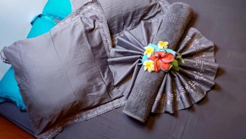 RotoavaAquaLodge Fakarava的床上一束带花的连衣裙