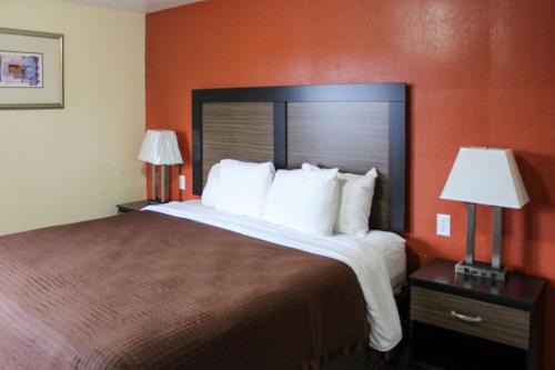梅德福梅德福旅馆的酒店客房设有一张大床和两盏灯。