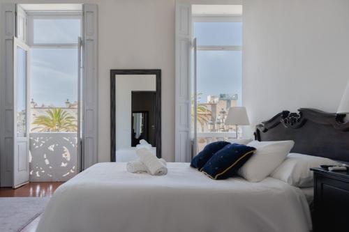 大加那利岛拉斯帕尔马斯Santa Ana Suite & Rooms的卧室配有一张白色大床和两条毛巾