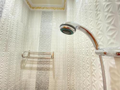 比拉Rumah Windy Guest House Bira的浴室内配有淋浴和头顶淋浴
