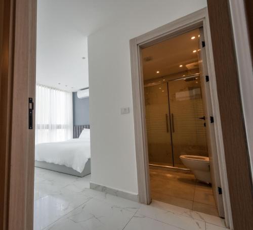 安曼Al Kawther Hotel Apartments的卧室内带淋浴和卫生间的浴室