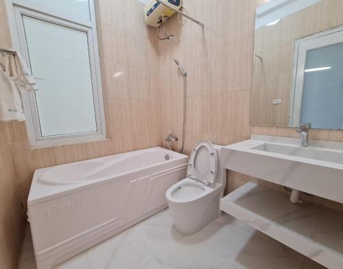清化Eureka Resort, Hai Tien Beach的浴室配有卫生间、浴缸和水槽。