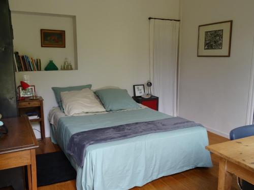 凯恩Chambre d'hôtes sur jardin acces PMR的一间卧室配有一张带蓝色棉被的床