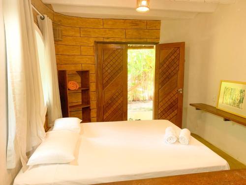 因巴塞Chalé Nova Terra的一间卧室配有一张床,上面有两条毛巾