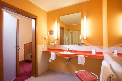 巴德哥依斯恩Vivea Hotel Bad Goisern的一间带水槽和镜子的浴室