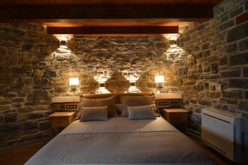 布罗托Hotel Rural El Portón de Murillo的卧室配有一张石墙床