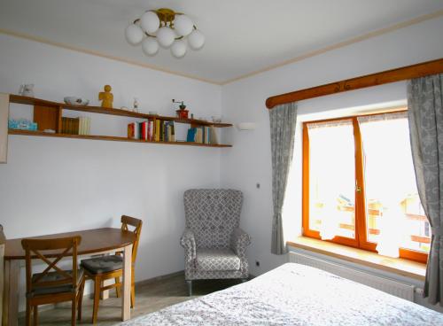 KoberovyStylový vesnický apartmán v soukromí M. Skála Český Ráj的一间卧室配有一张床、一张桌子和一把椅子