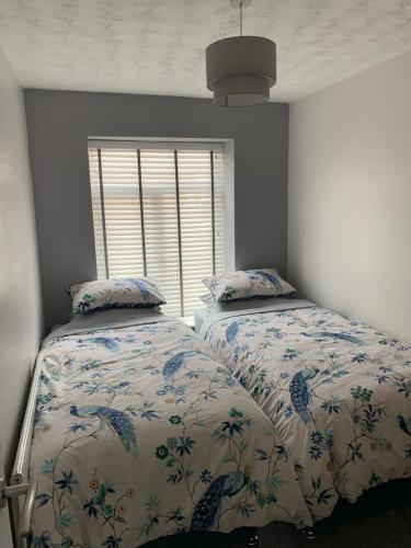 FarnworthThe Greens Apartment的一间卧室设有两张床和窗户。