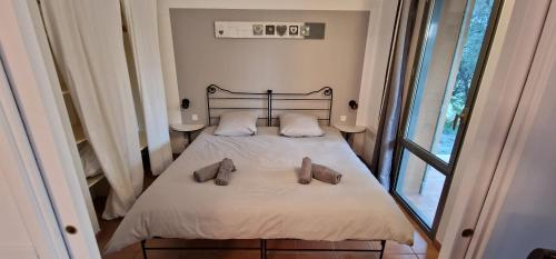 索马讷-德沃克吕兹Appartement sur golf de L'Isle-Sur-La-Sorgue的一间卧室,床上有两双鞋
