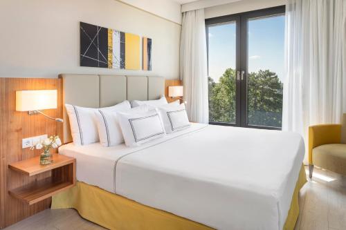 卢森堡卢森堡美利亚酒店的卧室设有一张白色大床和一扇窗户。