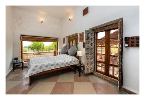 奥拉奇哈Chandera Kothi的一间卧室设有一张床和一个大窗户