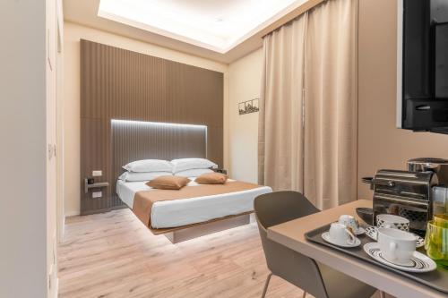 米兰Meneghina Suites Foresteria Lombarda的酒店客房设有一张床铺和一张桌子,还有一间用餐室