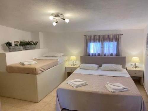 斯基亚索斯镇PORT SEA VIEW - SKIATHOS的一间卧室设有两张床和窗户。