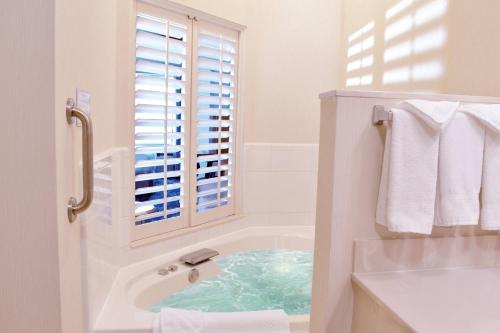 印第安纳波利斯东印第安纳波利斯费尔菲尔德客栈的白色的浴室设有浴缸和窗户。