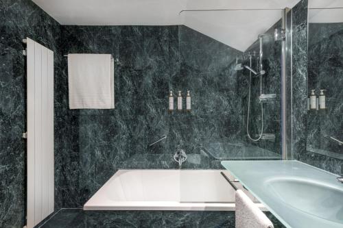 帕伦西亚帕伦西亚生活方式万豪AC酒店的黑色浴室设有浴缸和水槽
