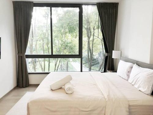 Ban Huai Sok NoiThe Valley byJT的一间卧室设有一张大床和大窗户