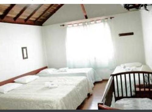 Pousada Capão do Índio客房内的一张或多张床位