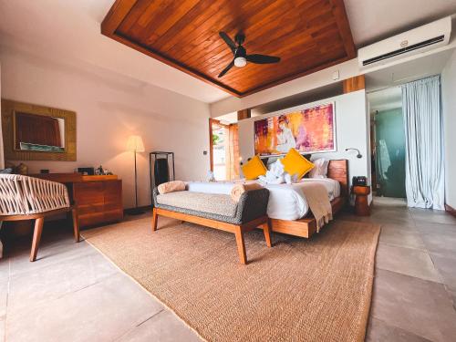 蒙舒瓦西Wonders Beach Boutique Hotel的一间卧室配有两张床和吊扇